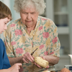 A boy and his grandma cutting ingredients