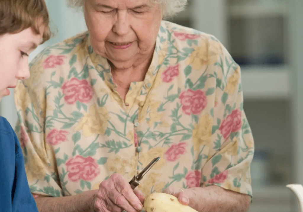 A boy and his grandma cutting ingredients